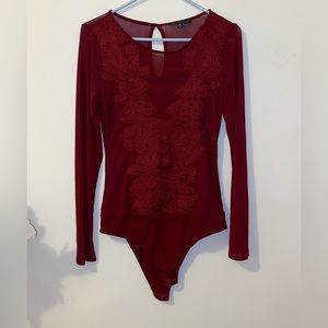 The mesh burgundy color bodysuit.